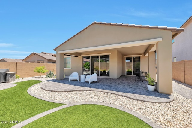 19908 W Montecito Ave, Litchfield Park, AZ 85340 - rear view of property featuring stucco siding, a patio area, and a fenced backyard