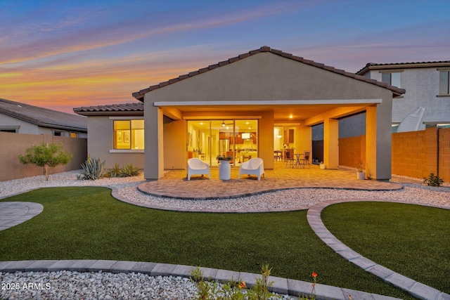 19908 W Montecito Ave, Litchfield Park, AZ 85340 - rear view of house featuring stucco siding, a patio area, a fenced backyard, and a tiled roof