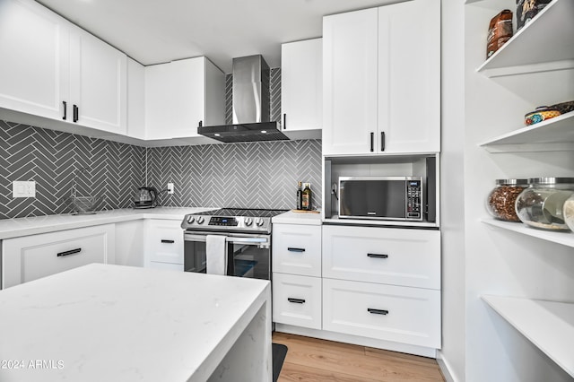 kitchen featuring white cabinetry, backsplash, stainless steel electric range, light stone countertops, and wall chimney exhaust hood