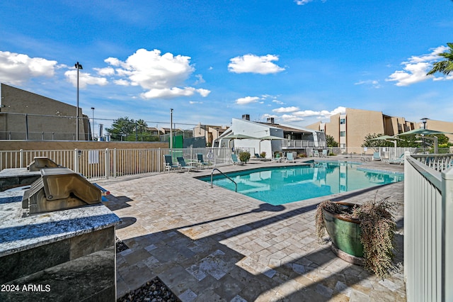 view of swimming pool featuring a patio