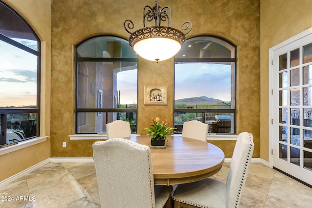 dining area with plenty of natural light and light tile floors