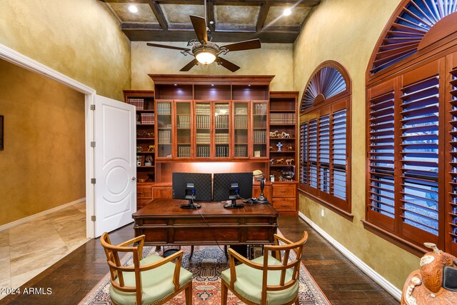 tiled office featuring coffered ceiling, a towering ceiling, and ceiling fan