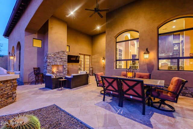 exterior space featuring ceiling fan and an outdoor living space with a fireplace