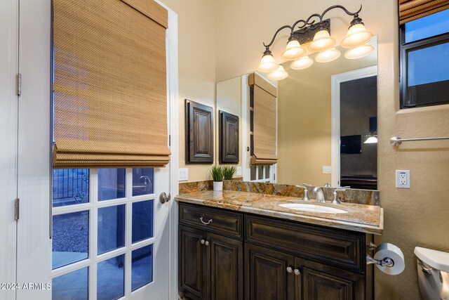 bathroom with toilet and vanity