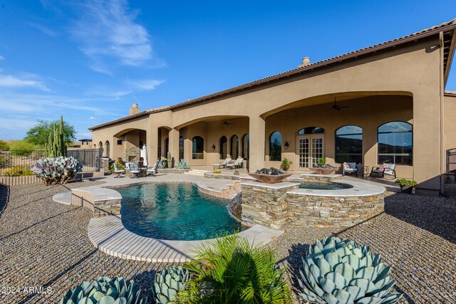 view of swimming pool with a patio area, french doors, ceiling fan, and an in ground hot tub