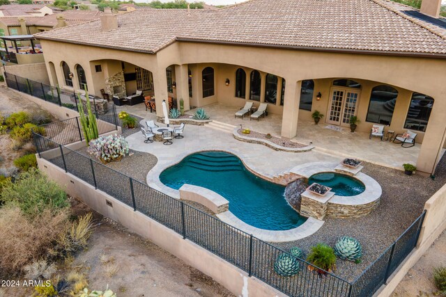 view of pool featuring french doors, an in ground hot tub, and a patio