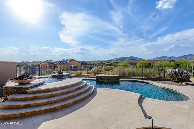 view of swimming pool featuring a patio area, a mountain view, and pool water feature