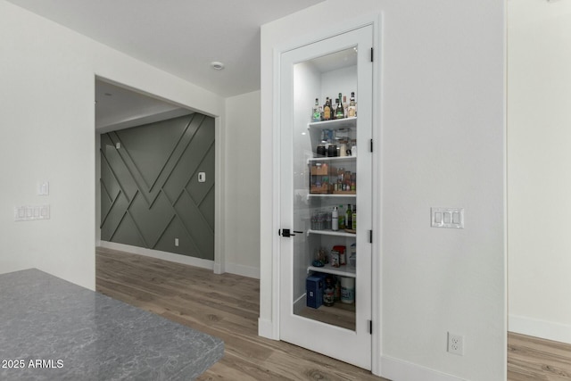 corridor featuring hardwood / wood-style floors