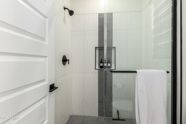 bathroom with a shower with door