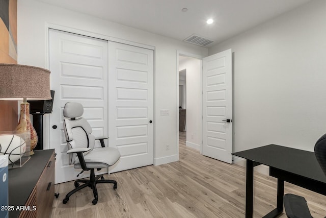 home office with light hardwood / wood-style floors