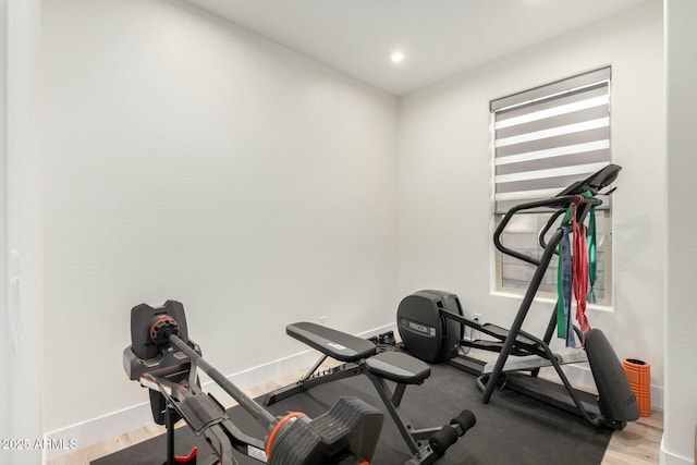 exercise room with light wood-type flooring