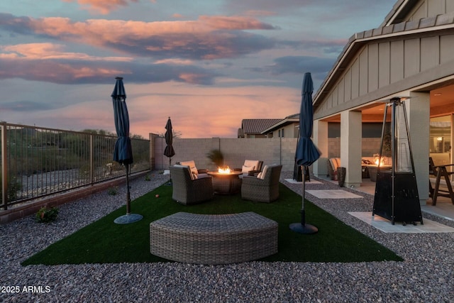 yard at dusk with a fire pit and a patio area