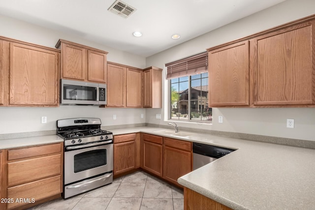 9148 W Meadow Dr, Peoria, AZ 85382 - kitchen with stainless steel appliances, a sink, light tile patterned floors, light countertops, and recessed lighting