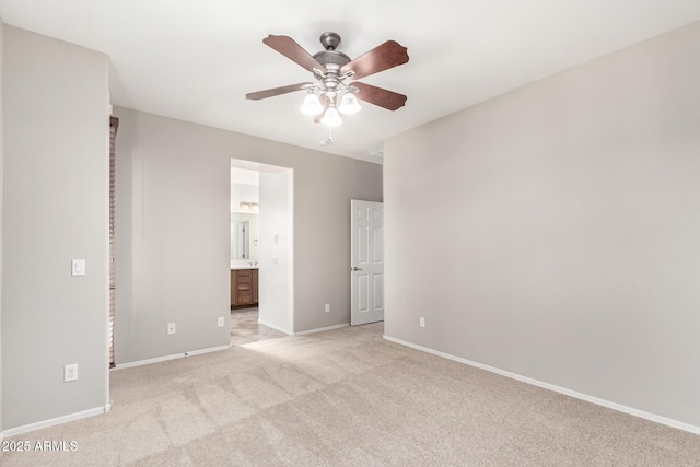9148 W Meadow Dr, Peoria, AZ 85382 - unfurnished bedroom featuring light colored carpet, baseboards, connected bathroom, and a ceiling fan
