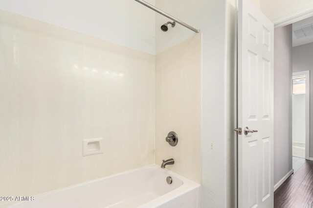 9148 W Meadow Dr, Peoria, AZ 85382 - full bathroom with washtub / shower combination, wood finished floors, and baseboards