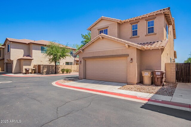 9148 W Meadow Dr, Peoria, AZ 85382 - view of front of home featuring stucco siding, a tile roof, fence, and concrete driveway