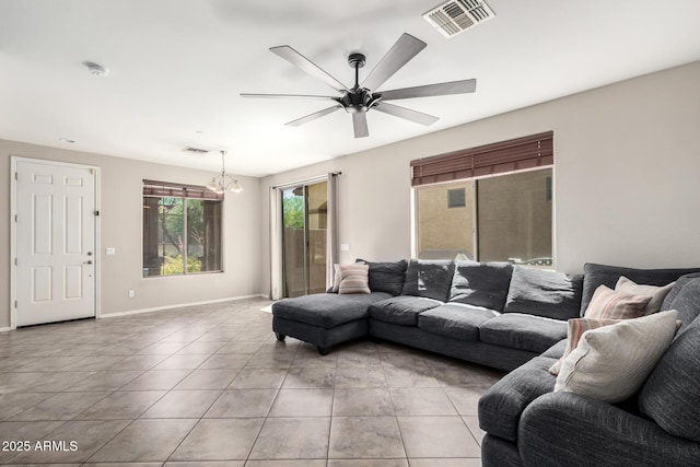9148 W Meadow Dr, Peoria, AZ 85382 - living room featuring a chandelier, light tile patterned flooring, a ceiling fan, and baseboards