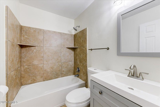 full bathroom with toilet, tiled shower / bath, and vanity