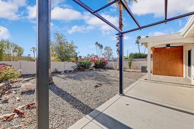 view of yard with central air condition unit and a patio