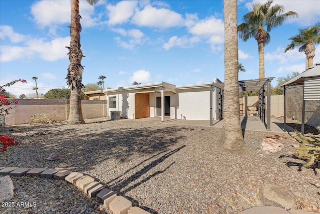 view of front of house featuring a patio area and central AC