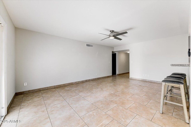 tiled empty room with ceiling fan