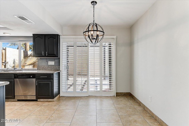 kitchen with sink, stainless steel dishwasher, plenty of natural light, and a notable chandelier