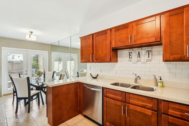 kitchen with sink, dishwasher, light stone counters, french doors, and light tile patterned floors