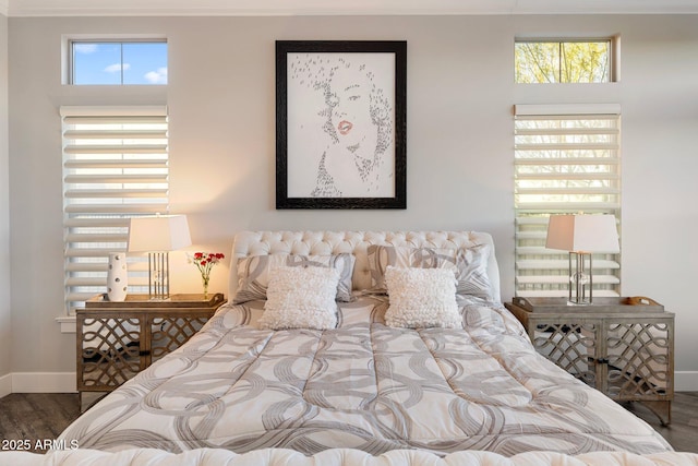 bedroom featuring wood finished floors and baseboards