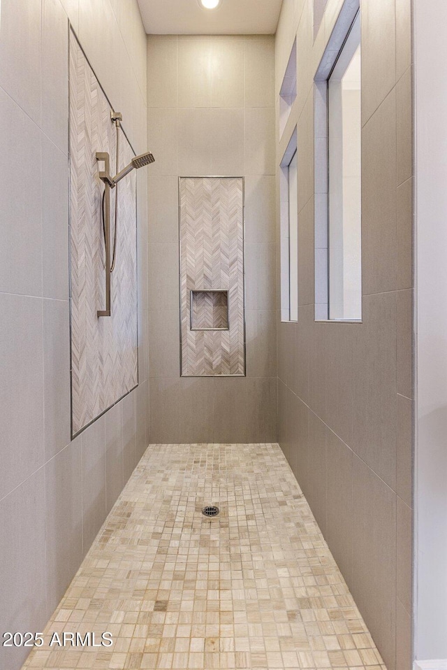 full bath with a tile shower