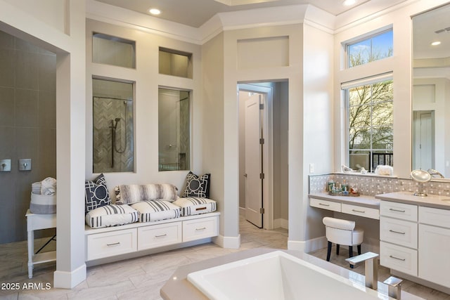 bathroom with visible vents, tasteful backsplash, vanity, and baseboards