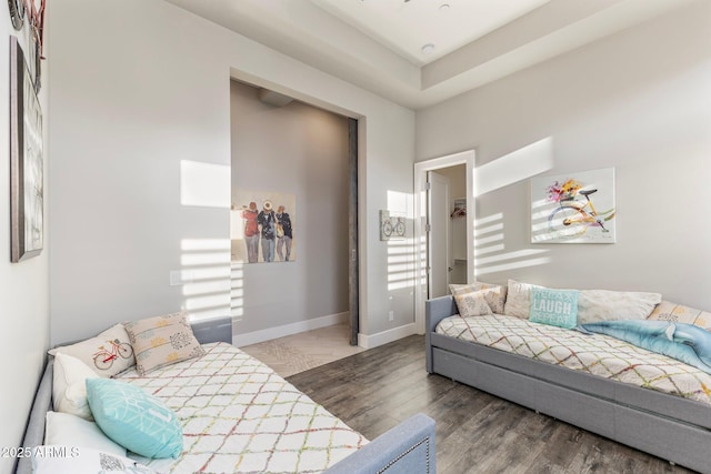 bedroom with baseboards and wood finished floors