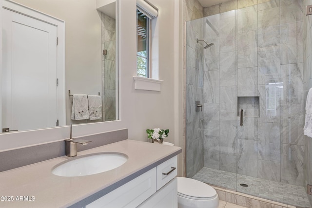 full bath featuring toilet, a stall shower, and vanity