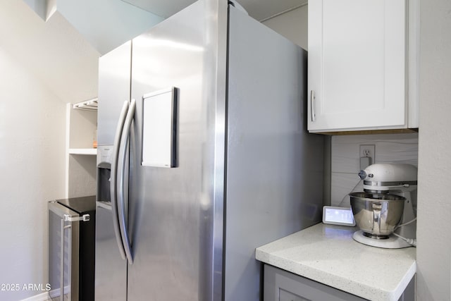 8135 N Central Ave Unit 1, Phoenix, AZ 85020 - kitchen featuring stainless steel refrigerator with ice dispenser, beverage cooler, white cabinetry, tasteful backsplash, and light stone countertops