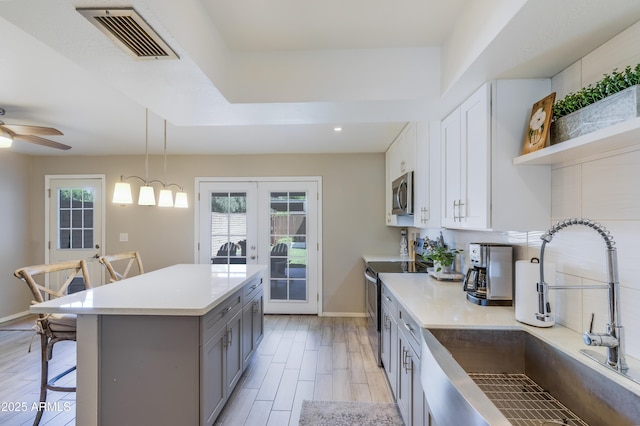 8135 N Central Ave Unit 1, Phoenix, AZ 85020 - kitchen featuring a sink, gray cabinets, appliances with stainless steel finishes, french doors, and healthy amount of natural light