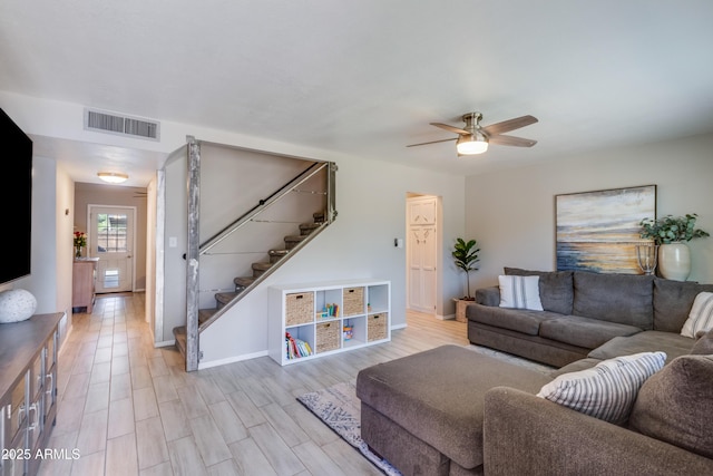 8135 N Central Ave Unit 1, Phoenix, AZ 85020 - living room featuring stairway, ceiling fan, baseboards, and light wood finished floors