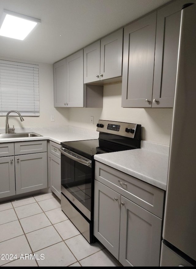 kitchen with gray cabinets, sink, and appliances with stainless steel finishes