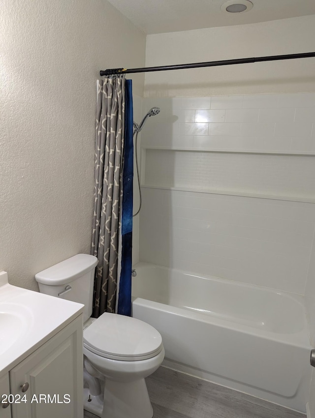 full bathroom with toilet, vanity, hardwood / wood-style flooring, and shower / tub combo with curtain