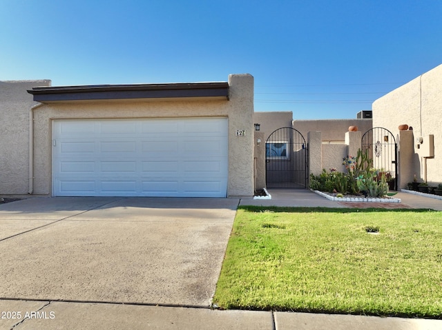 3345 E University Dr Unit 2, Mesa, AZ 85213 - view of front of house featuring driveway, stucco siding, an attached garage, a gate, and a front yard