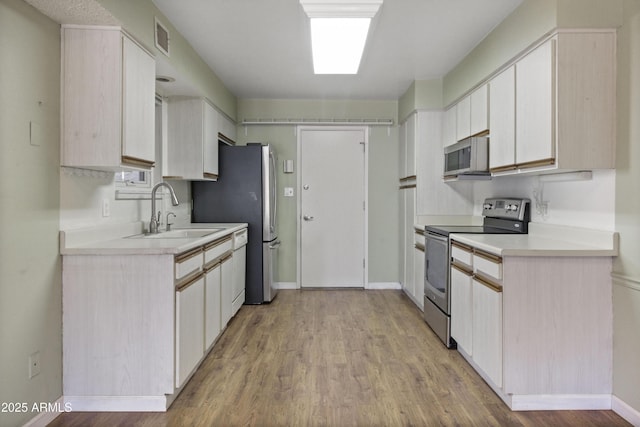 3345 E University Dr Unit 2, Mesa, AZ 85213 - kitchen with stainless steel appliances, light countertops, and light wood-style floors