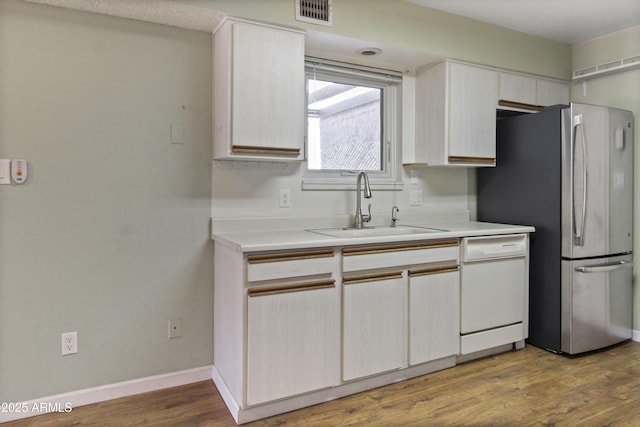 3345 E University Dr Unit 2, Mesa, AZ 85213 - kitchen featuring white dishwasher, freestanding refrigerator, light countertops, and wood finished floors