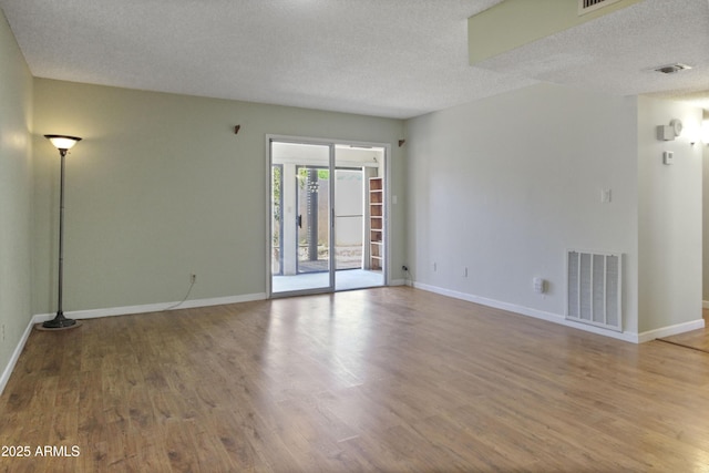 3345 E University Dr Unit 2, Mesa, AZ 85213 - empty room featuring wood finished floors and a textured ceiling