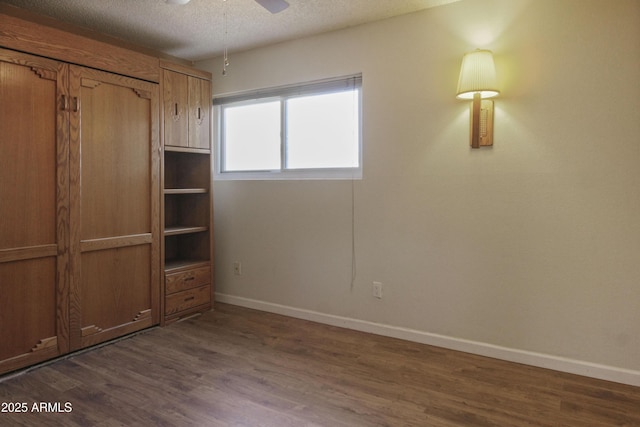 3345 E University Dr Unit 2, Mesa, AZ 85213 - unfurnished bedroom featuring dark wood-style floors, a textured ceiling, and ceiling fan