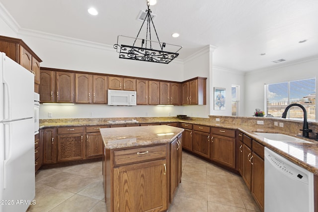 kitchen featuring sink, pendant lighting, white appliances, a kitchen island, and ornamental molding