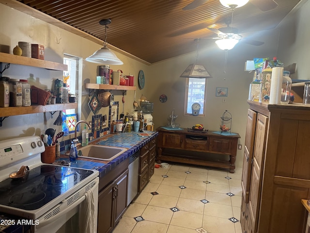 kitchen with dark brown cabinetry, sink, light tile patterned floors, dishwasher, and electric stove