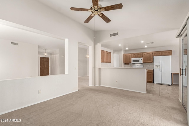 unfurnished living room with light carpet, vaulted ceiling, and ceiling fan