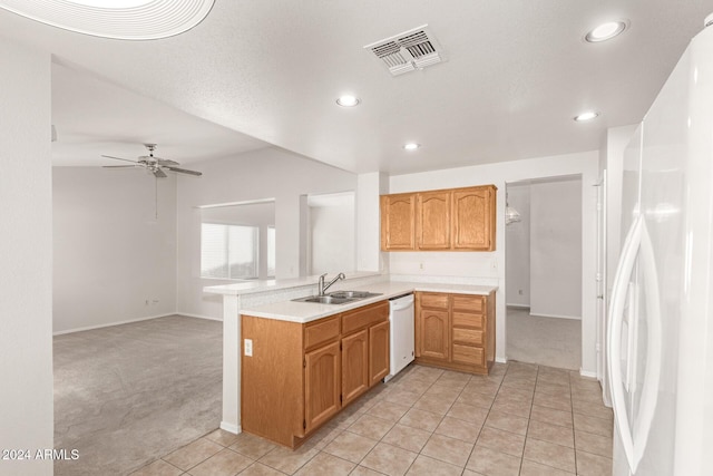 kitchen featuring kitchen peninsula, white appliances, light colored carpet, ceiling fan, and sink