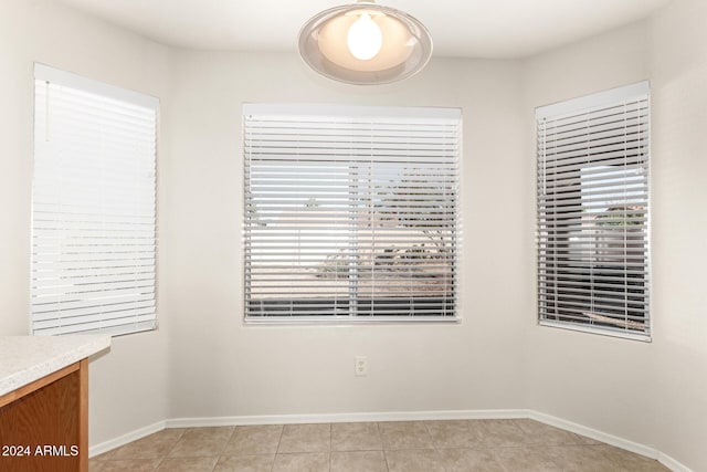 tiled empty room with a wealth of natural light