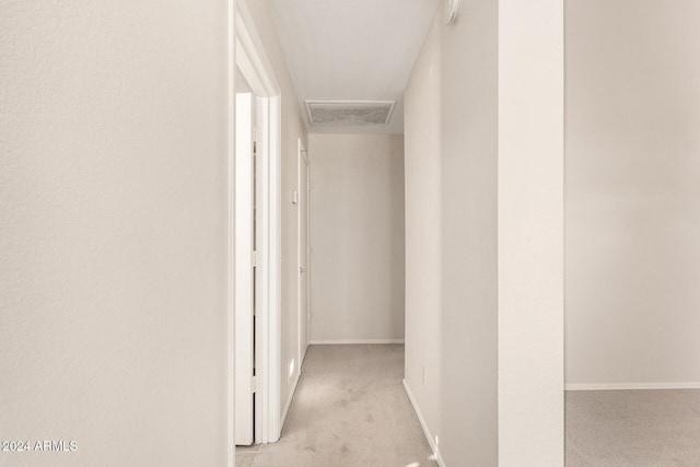 hallway featuring light colored carpet