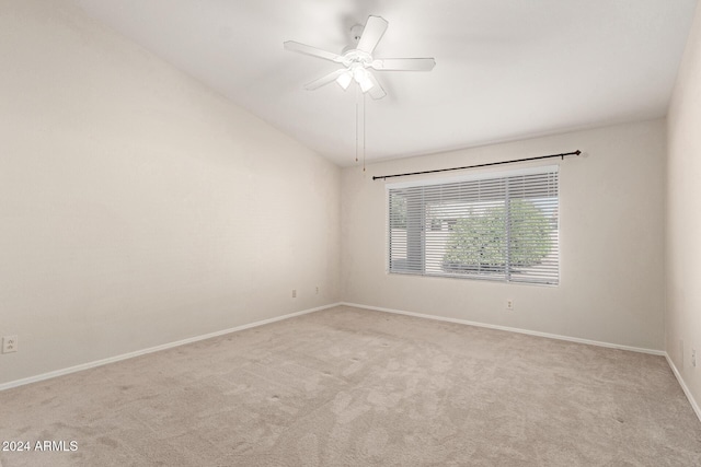 carpeted spare room featuring ceiling fan and lofted ceiling