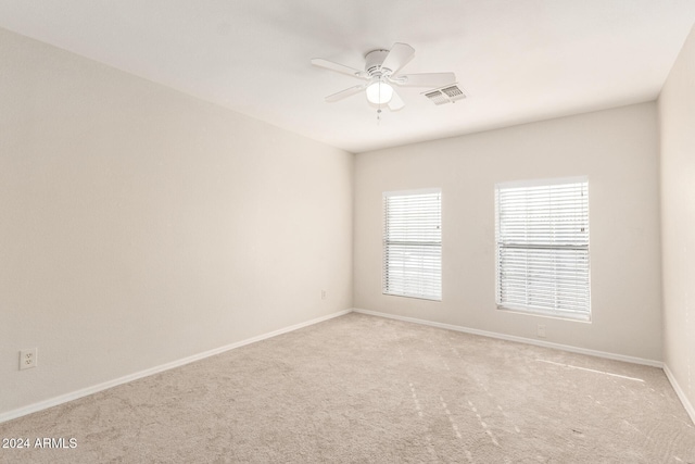 spare room with light carpet and ceiling fan